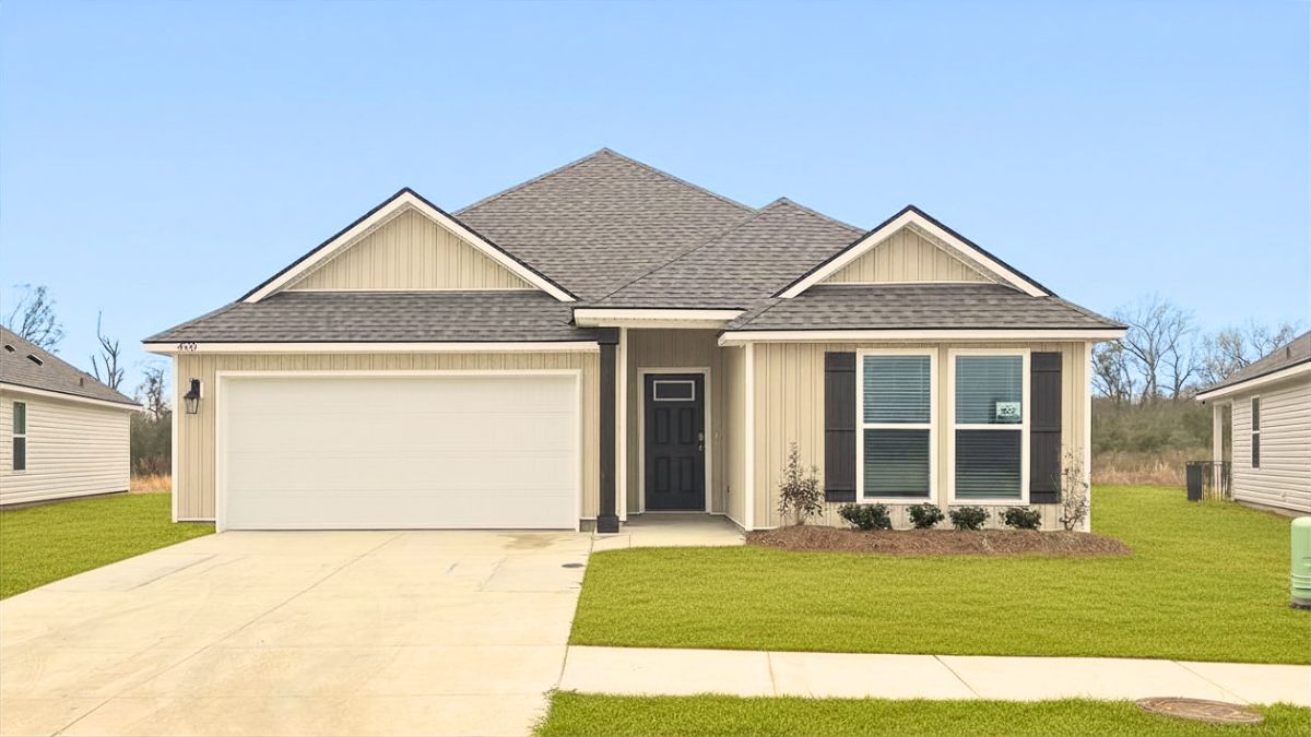 single-story home with tan vinyl siding with black front door and shutters with two-car garage
