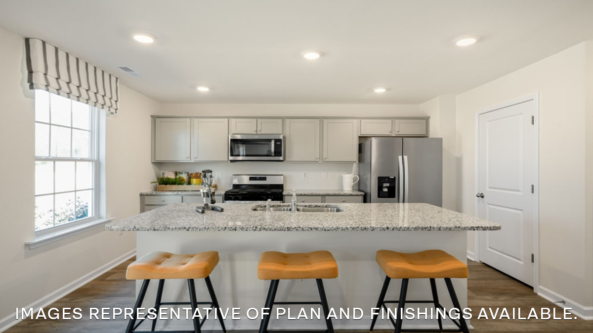 white kitchen island with stainless steel appliances and stools and pantry access