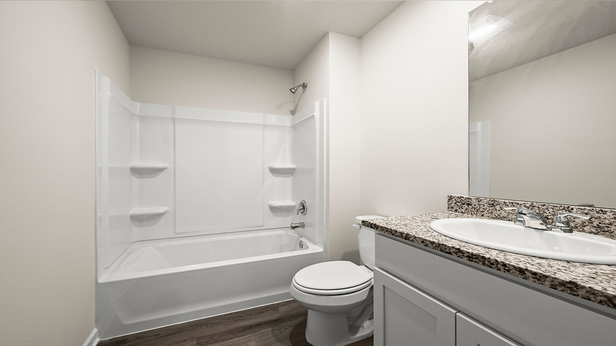 Guest bathroom with single vanity mirror and shower tub combo