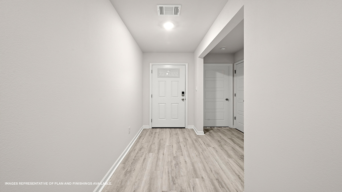 foyer with access to guest bedrooms at entrance of home
