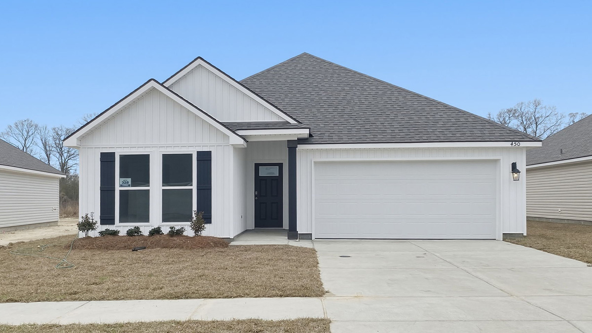 single-story home with white vinyl siding with black front door and shutters with two-car garage