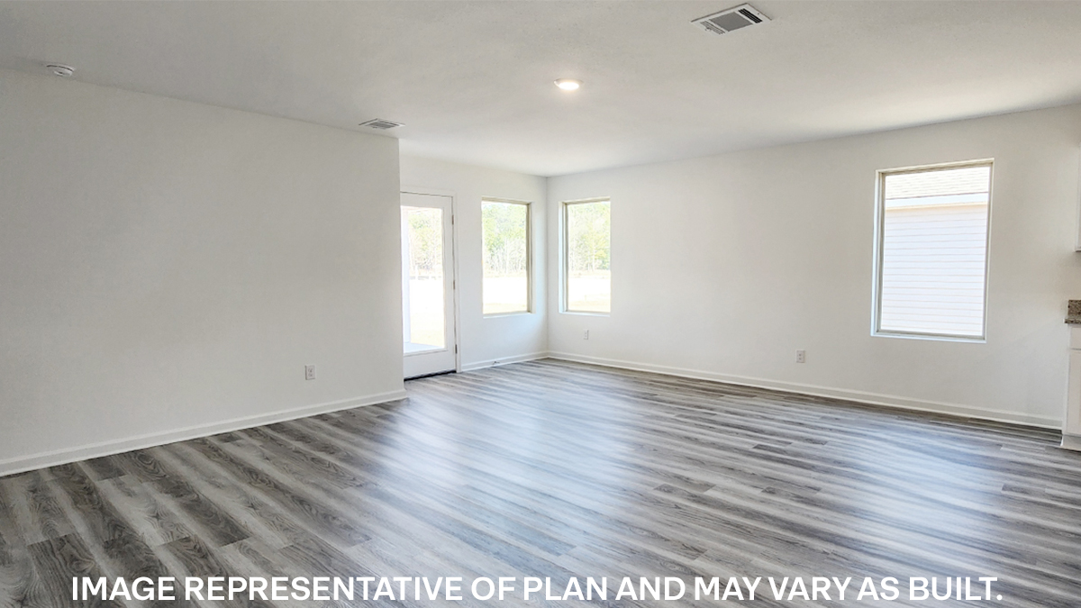 spacious living room with dual windows overlooking backyard