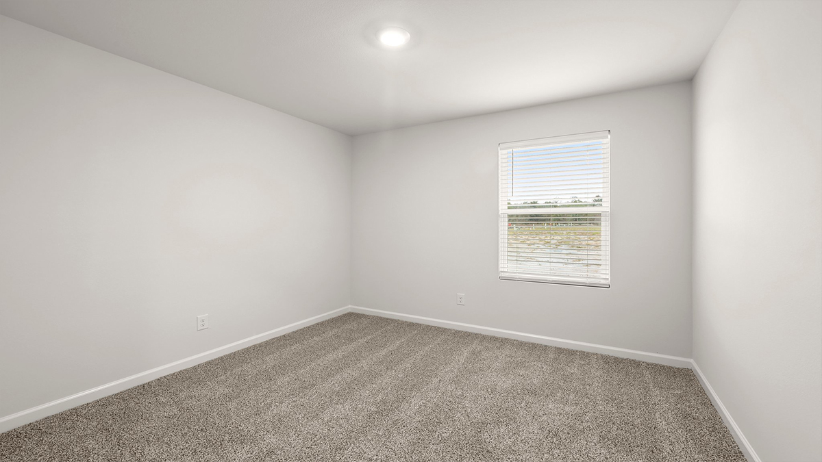 third bedroom with single window and room for a queen bed