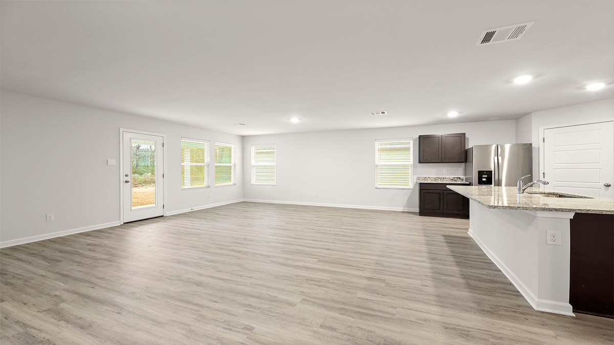 dining room near kitchen with dual windows adjacent to living room