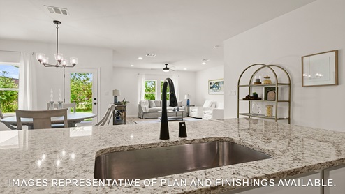 white kitchen island overlooking open concept living space