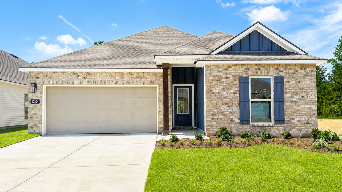 Single-story home with tan brick. Blue glass front door with blue shutters and white trim. Tan two car garage with blue hardi vinyl