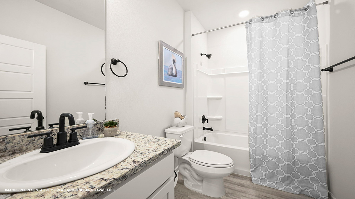 Guest bathroom with single vanity mirror and shower tub combo