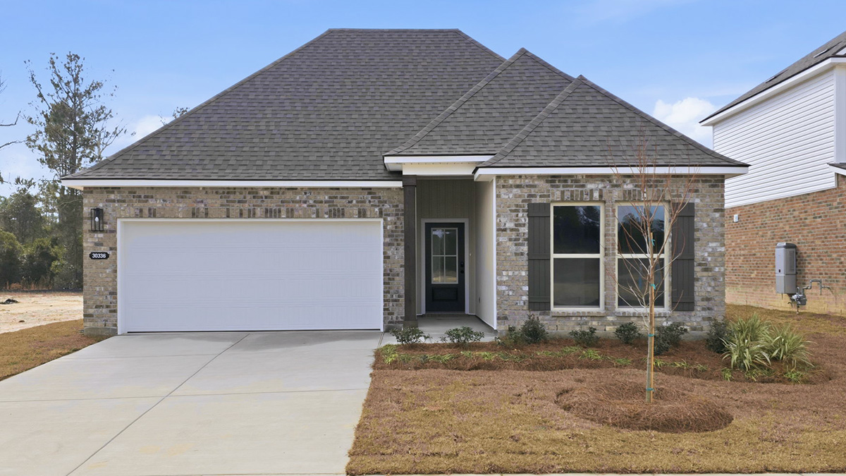 single-story home with grey brick and bleck front door and shutters with two-car garage
