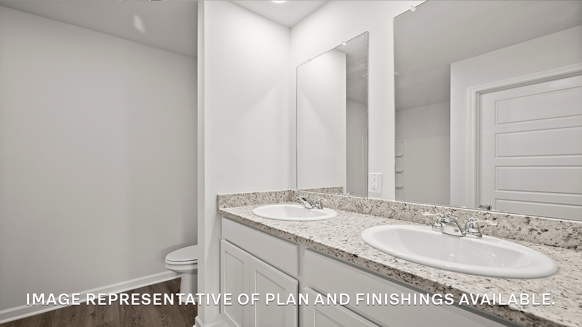 White dual vanities with mirrors in the primary bathroom