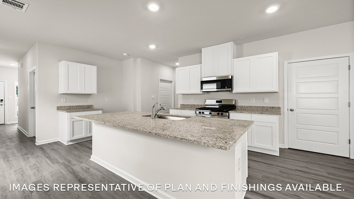 white kitchen island with stainless steel appliances and stools with access to pantry