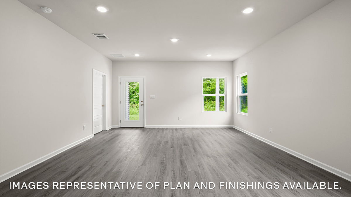 spacious living room with dual windows overlooking backyard
