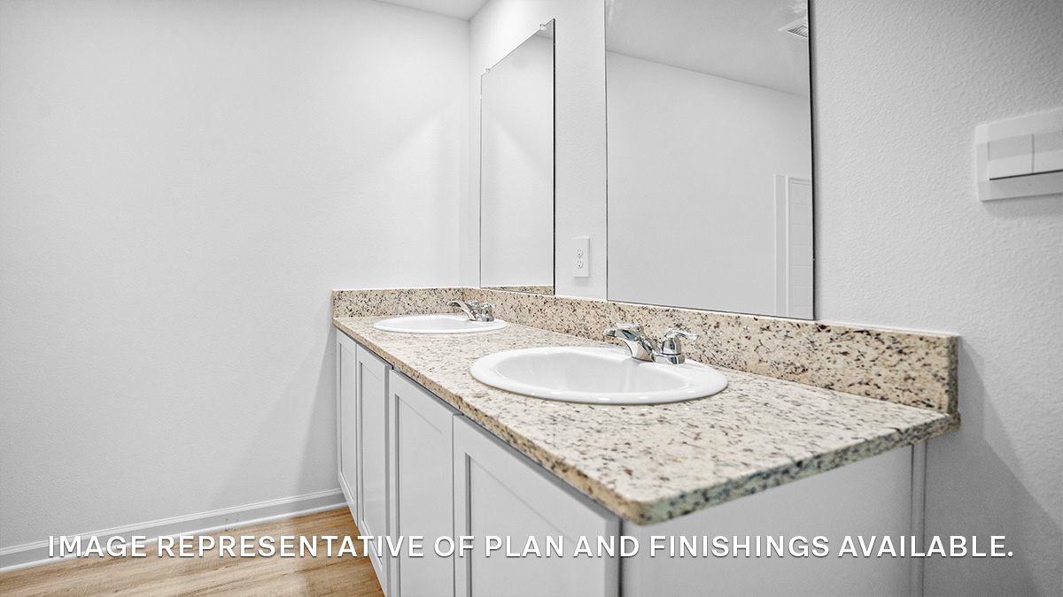 White dual vanities with shower and tub combo and toilet