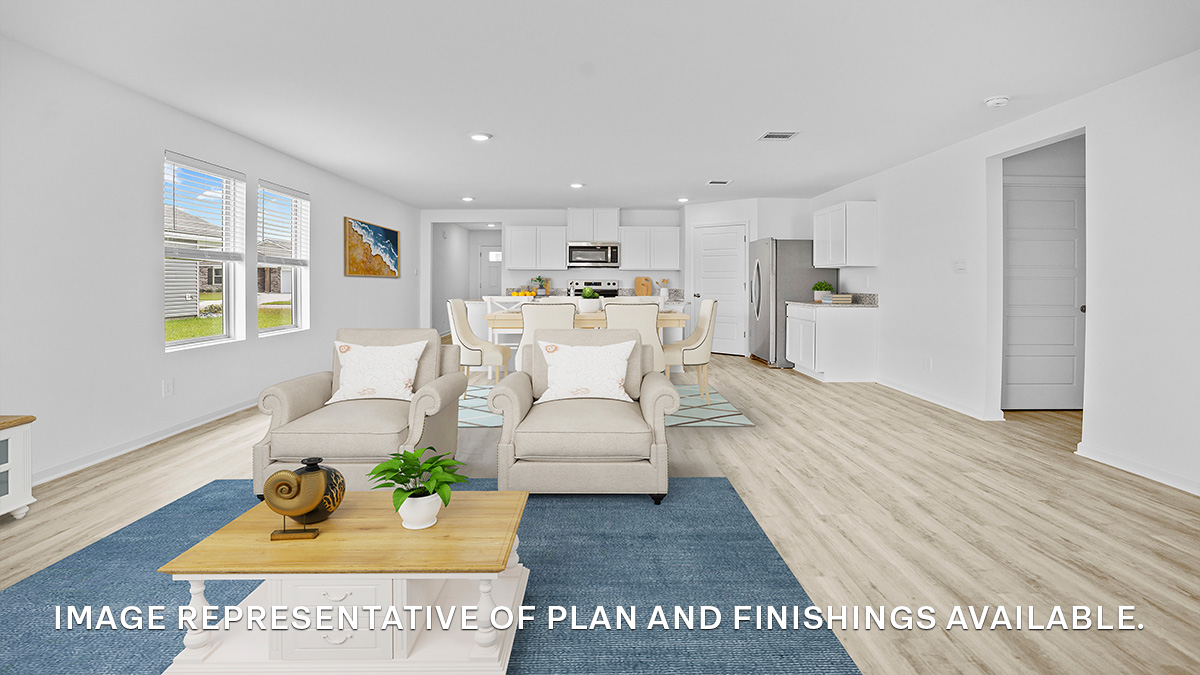 Open-concept living room with dual windows facing backyard and access to open kitchen