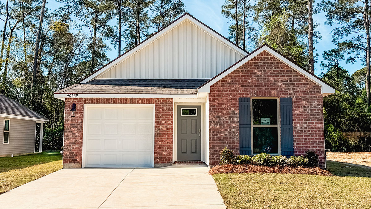 single-story home with red brick and tan vinyl siding with one-car garage