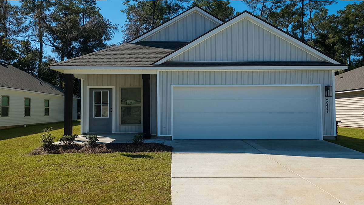 single-story home with light gray vinyl with dark gray front door and two-car garage