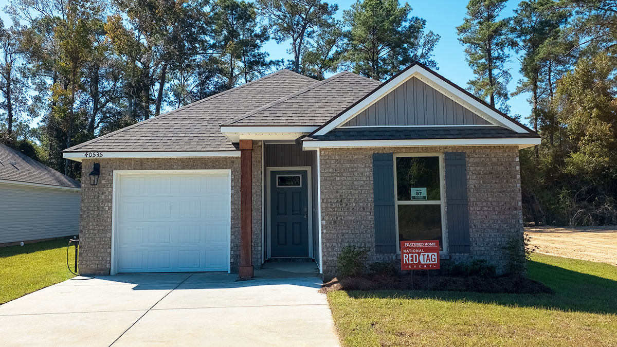 single-story home with tan brick and grey vinyl siding with grey front door and shutters with one-car garage