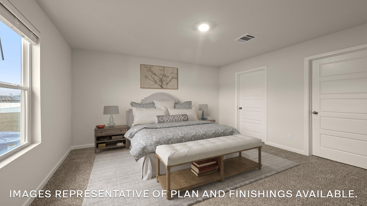 Primary bedroom with dual windows and opening to en suite and walk in closet