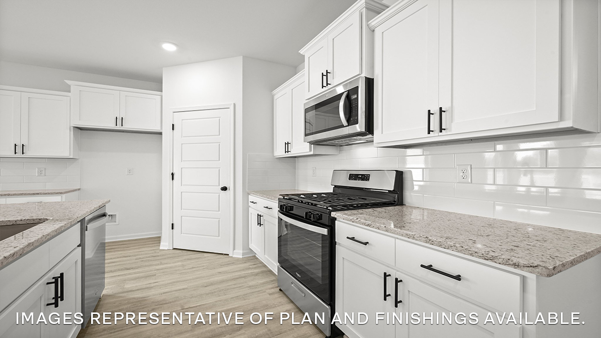white kitchen island with stainless steel appliances