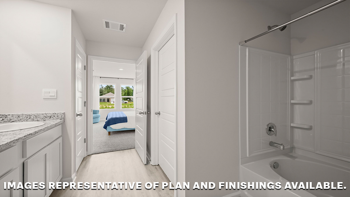 shower and tub combo and toilet in the primary bathroom