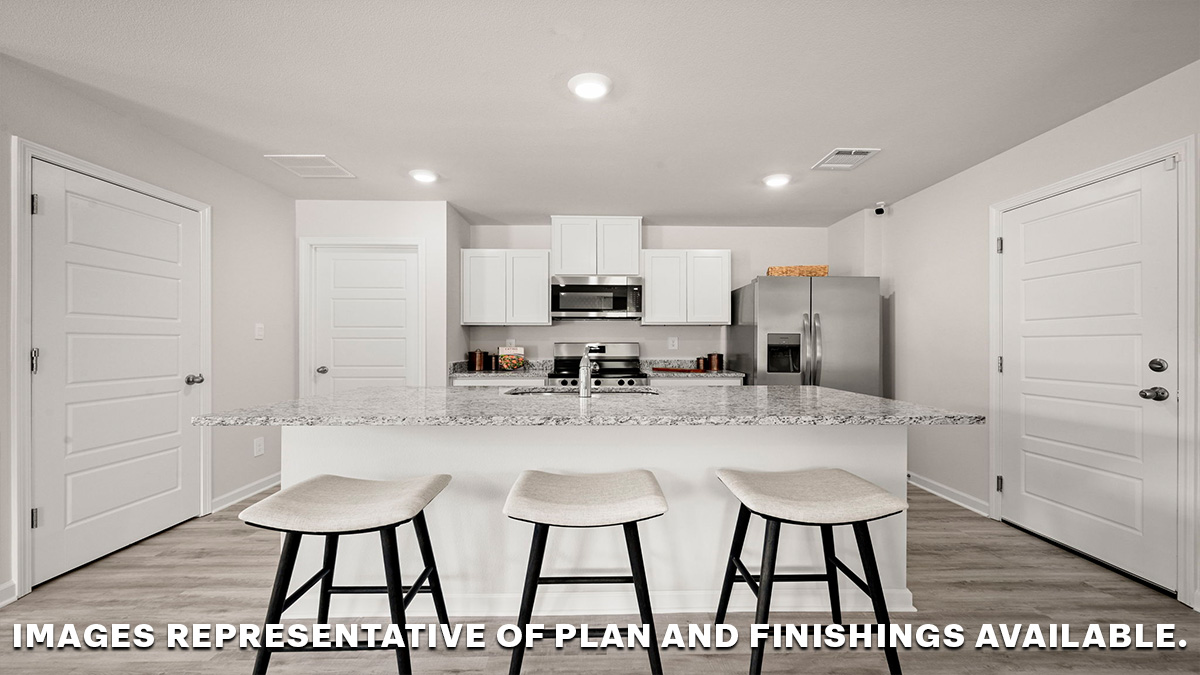 White kitchen island and foyer with access to front of home