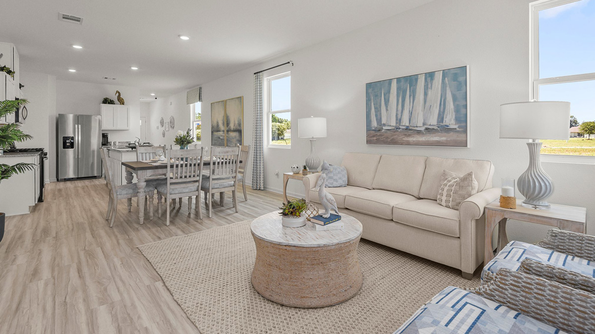 spacious living room with dual windows overlooking backyard