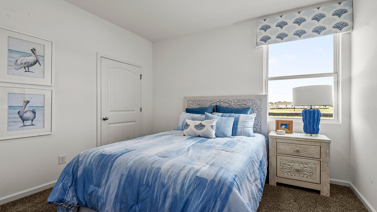 second bedroom with single window and room for a queen bed