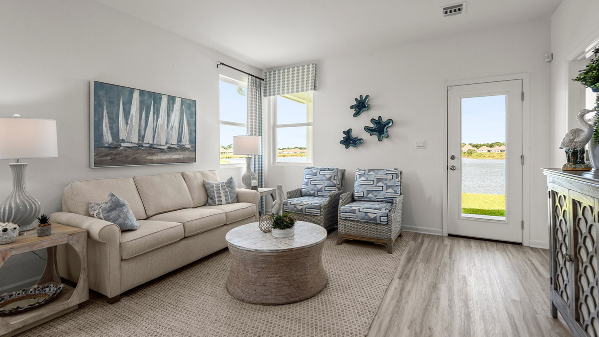 spacious living room with dual windows overlooking backyard
