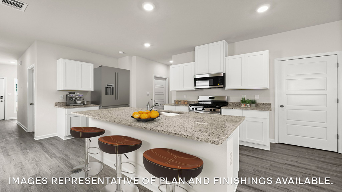 white kitchen island with stainless steel appliances and stools with access to pantry