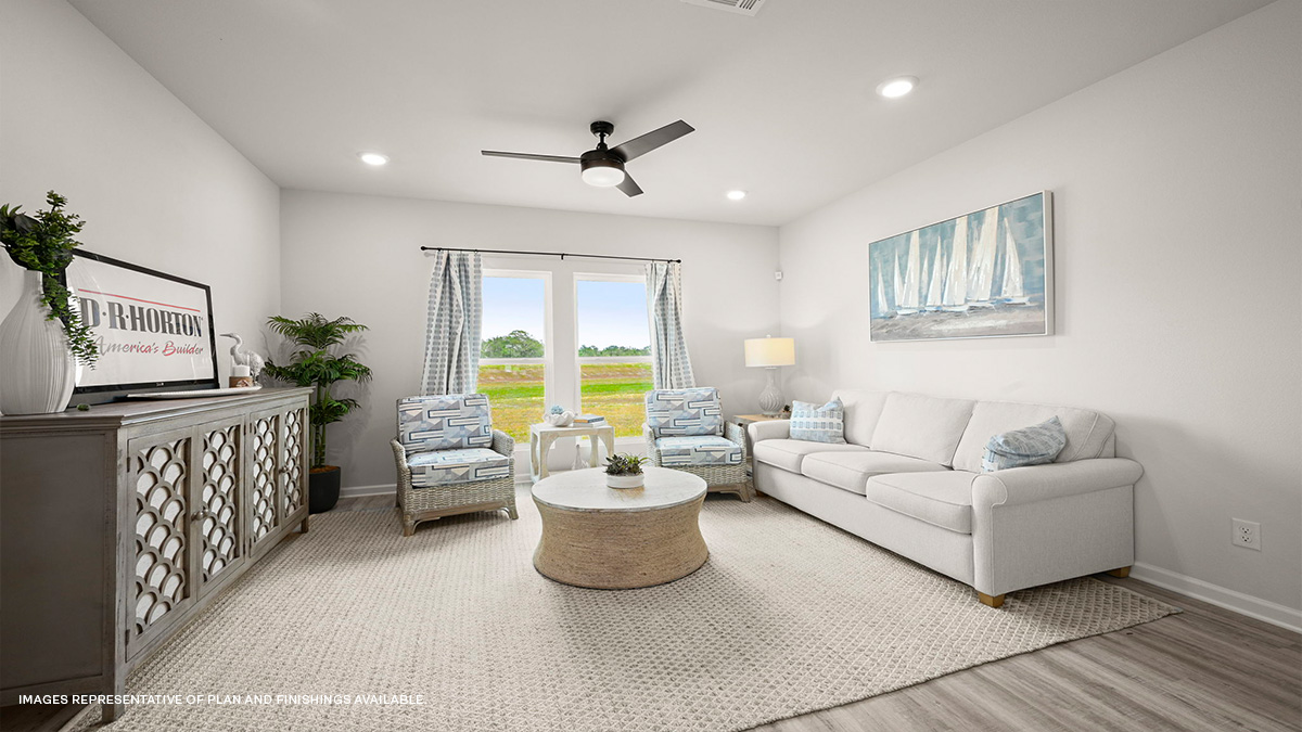 Open-concept living room with dual windows facing backyard