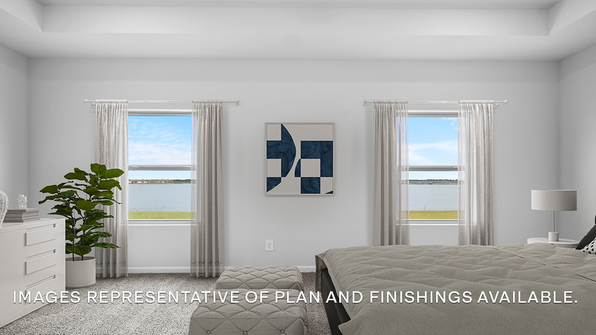 Large primary bedroom with dual windows overlooking the backyard