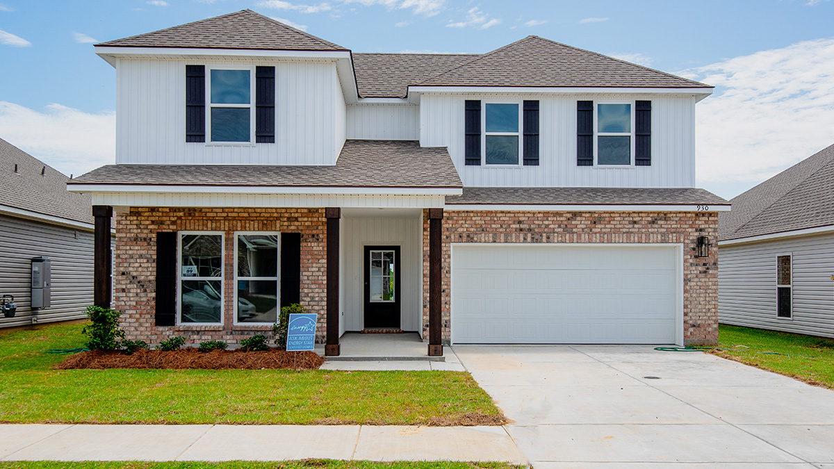 two-story home with brown brick and white vinyl siding with black front door and shutters with two-car garage and large porch