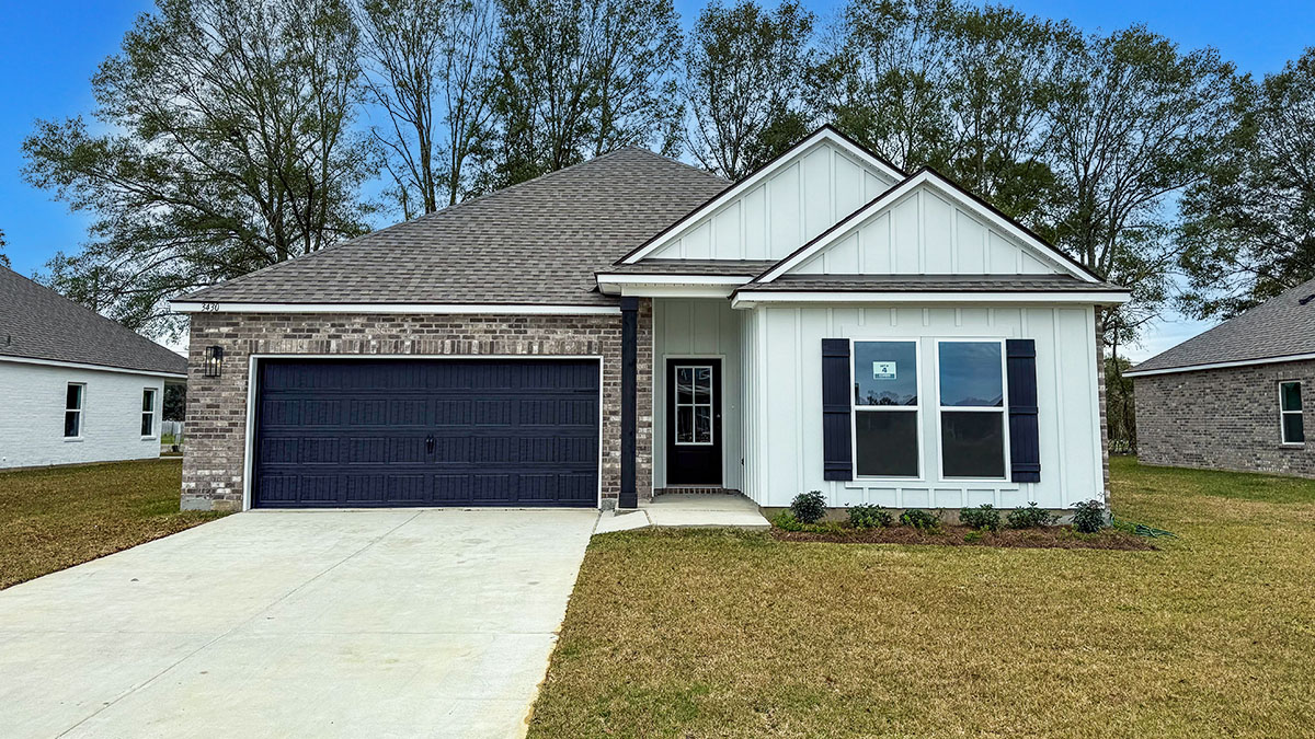 single-story home with white hardie siding and gray siding with black front door and shutters with two-car garage