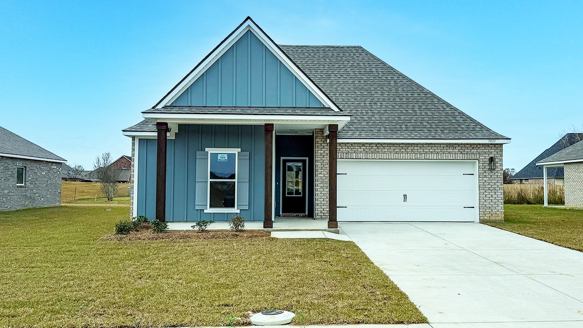 single-story home with blue hardie vinyl with tan brick and blur front door and light shutters with porch and two-car garage