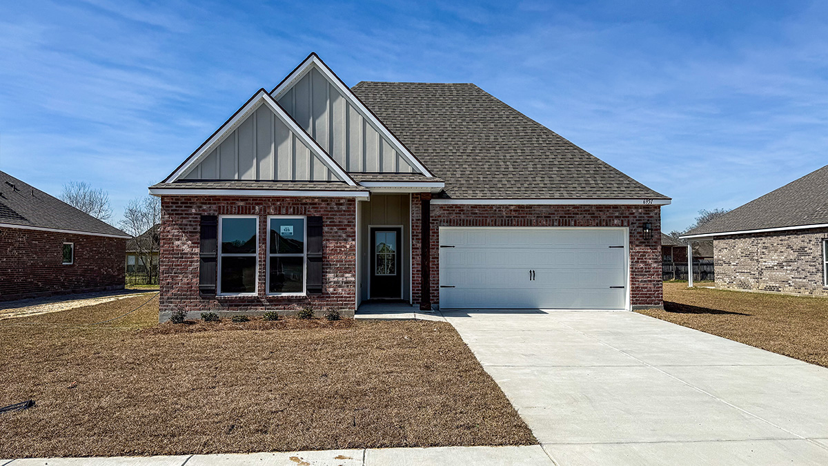 single-story home with brown brick with tan vinyl siding with brown front door and shutters with two-car garage