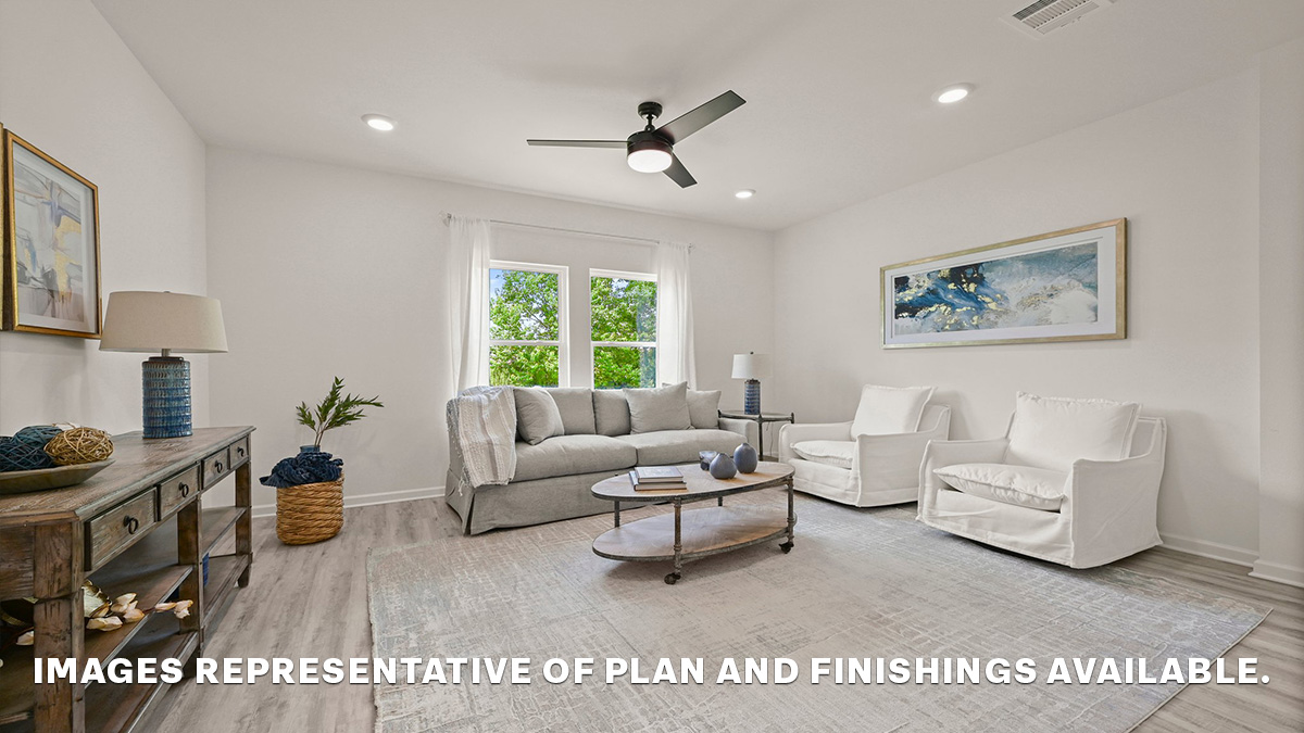 spacious living room with dual windows overlooking backyard