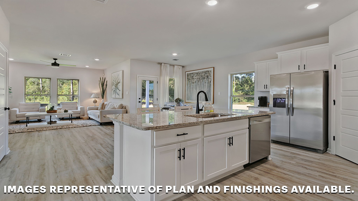 White kitchen island with stainless steel appliances with pantry access