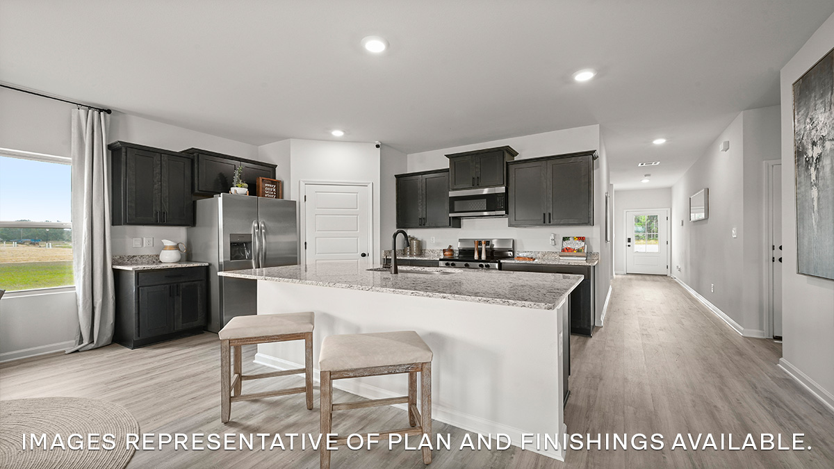 White kitchen island with stainless steel appliances with pantry access