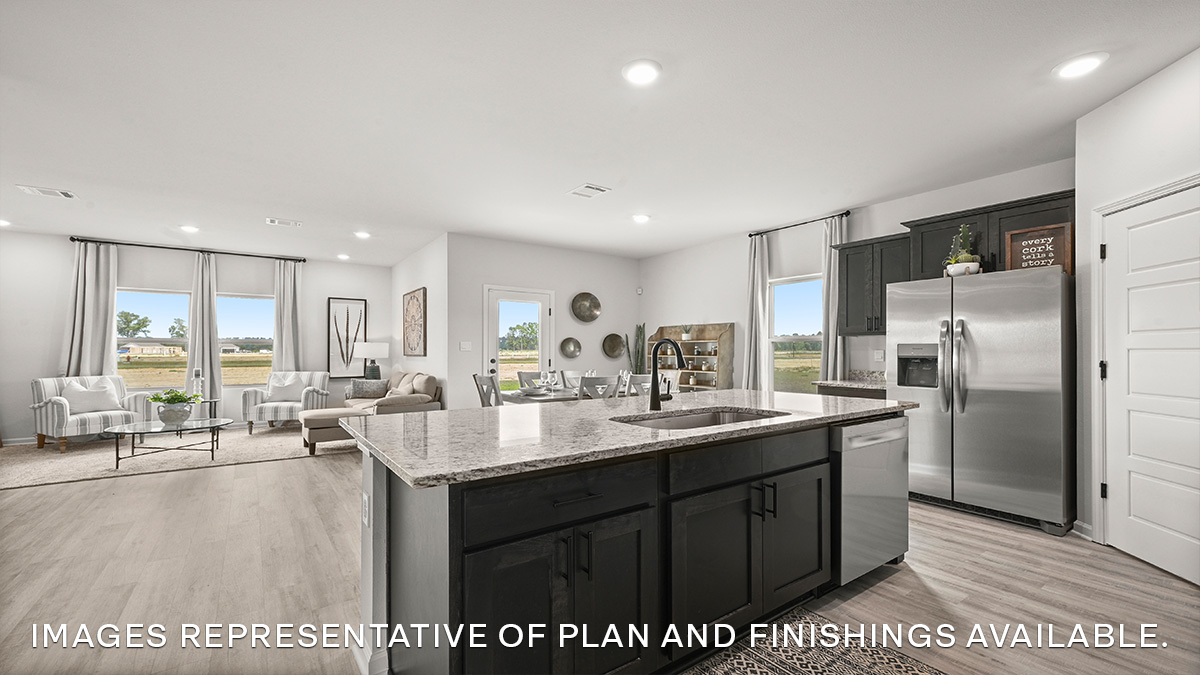 white kitchen island and gray granite overlooking the living space