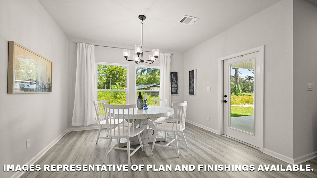 dining space with dual windows showing the backyard with patio door