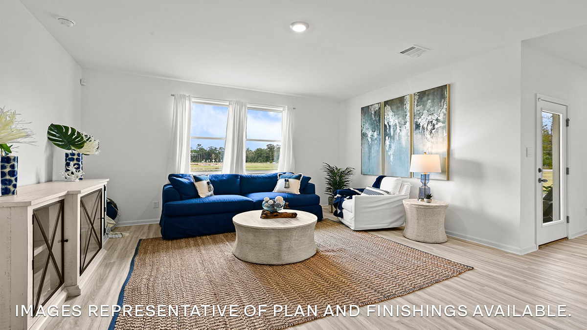 spacious living room with dual windows overlooking backyard