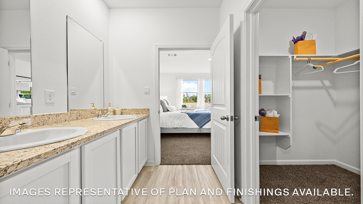 white dual vanities in primary bedroom and walk in closet