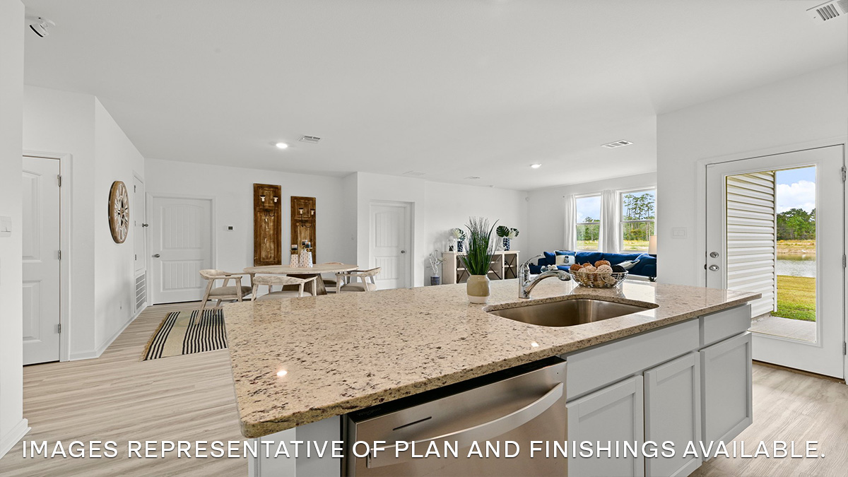 white kitchen island overlooking open-concept dining and living room