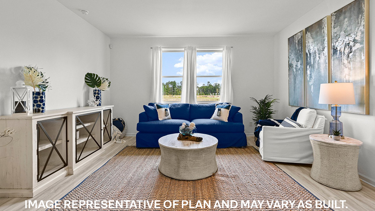 spacious living room with dual windows overlooking backyard
