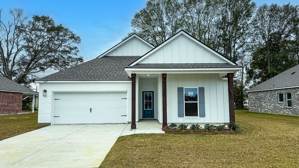 single-story home with white hardie vinyl and gray front door and shutters with two-car garage