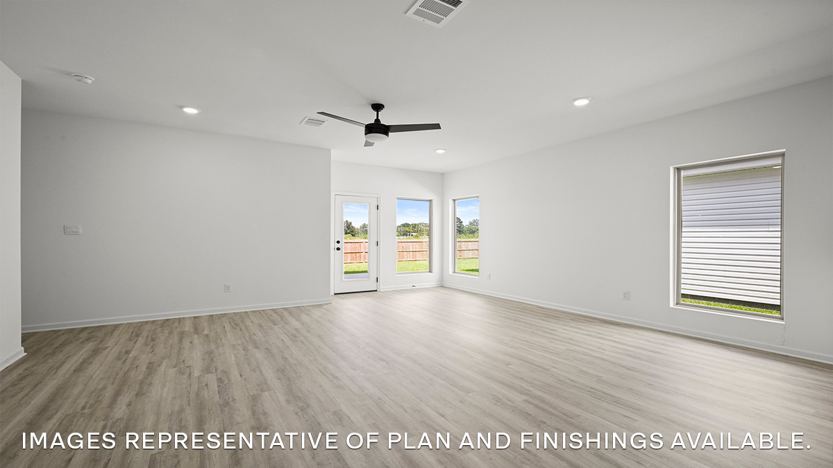 spacious living room with dual windows overlooking backyard