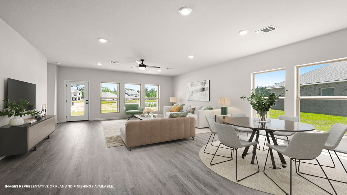 open-concept living space with dual windows on side and rear with patio access