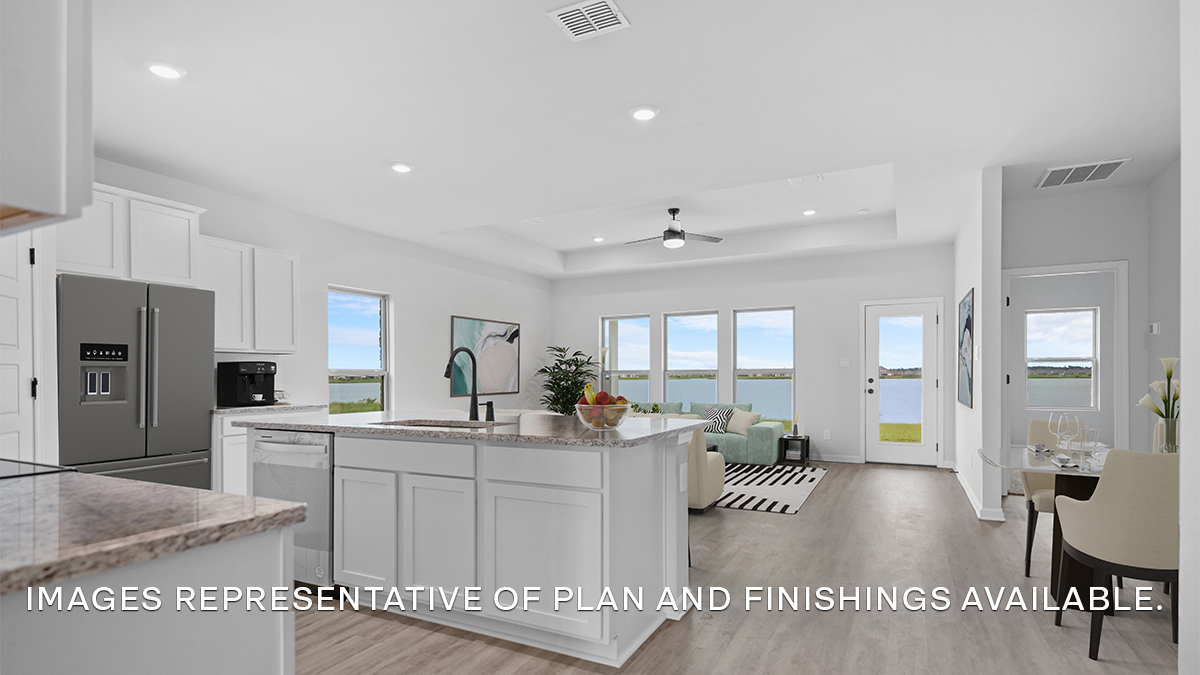 Open-concept kitchen, living and dining space with access to patio