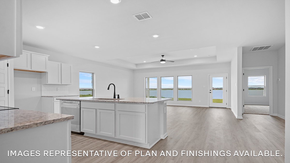 Open-concept kitchen, living and dining space with access to patio