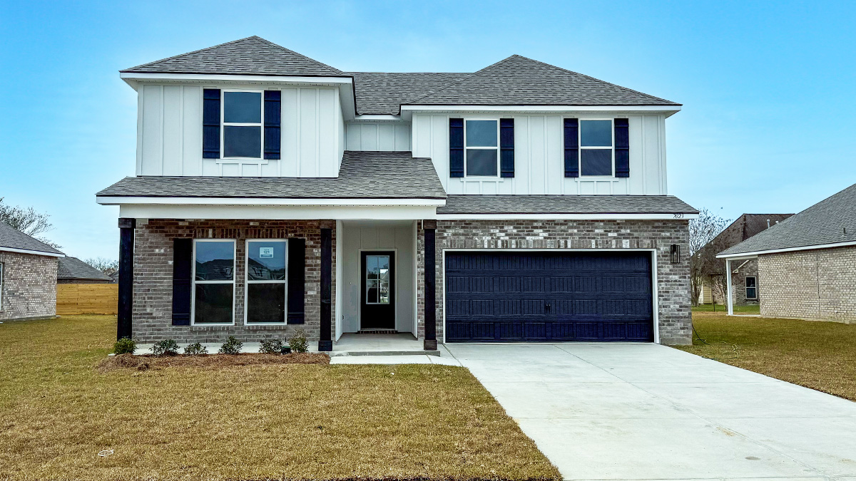 dual-story home with white hardie siding and gray brick and black front door and shutters with two-car garage