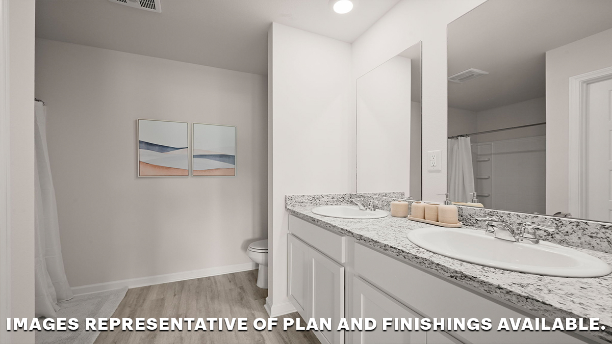 White dual vanities with mirrors in the primary bathroom